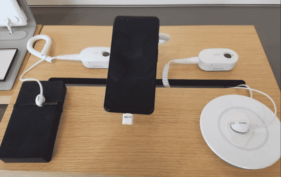 A wireless tether as a supplement to a physical tether in a Verizon store.